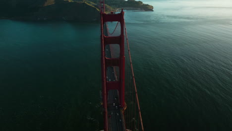 Flying-Over-Famous-Golden-Gate-Bridge-With-Traffic-At-Sunrise-In-California,-USA