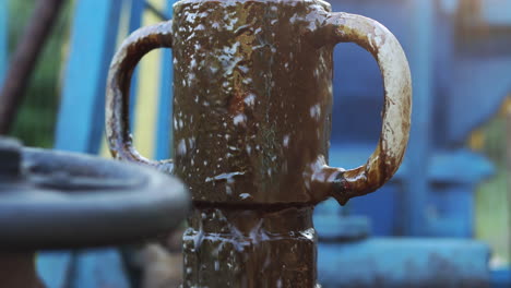 Close-up-of-crude-oil-overflowing-stuffing-box-of-pumpjack