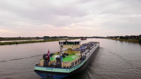 Aerial-Dolly-Left-Behind-Stern-Of-Ellen-Liquid-Tanker-Along-River-Noord
