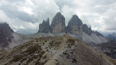 A-man-are-enjoying-the-view-of-Tre-Cime-di-Lavaredo-in-the-Dolomites-of-North-Italy