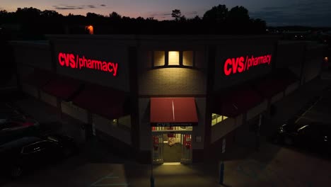 Female-customer-enters-CVS-Pharmacy-drugstore-at-night