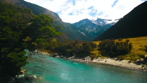 Aerial-overlooking-magnificent-crystal-clear-turquoise-color-mountain-river-in-Mount-Aspiring-National-Park---dolly-slide-right