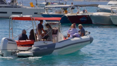 Tourist-on-a-boat-leaving-Hvar-harbor,-Croatia-slowed-to-half-speed