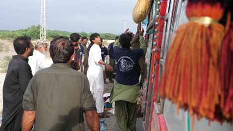 Side-View-Of-Flood-Relief-Package-Sacks-Lowered-From-Truck-In-Balochistan