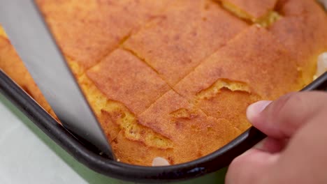 Cutting-corn-pie-in-the-baking-tray-closeup-look