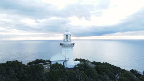Scenic-aerial-panorama-of-the-Smoky-Cape-Lighthouse-located-on-a-narrow-coastal-headland