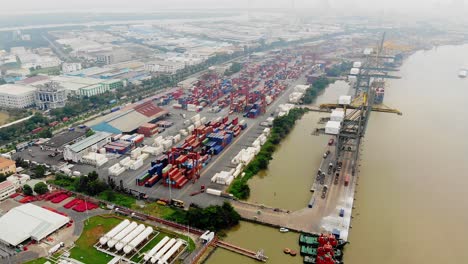 Top-aerial-view-of-stacked-container-terminal-on-Song-Sai-Gon,-Vietnam