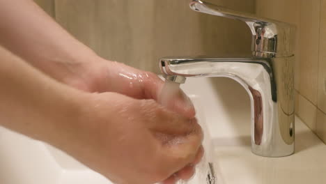 Washing-hands-in-the-bathroom