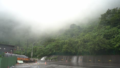 Tilt-up-shot-capturing-the-dangerous-weather-condition-with-heavy-rainfall-and-fog-caused-hazardous-driving-visibility-at-Hsuehshan-Tunnel-at-Hualien-City,-Taiwan