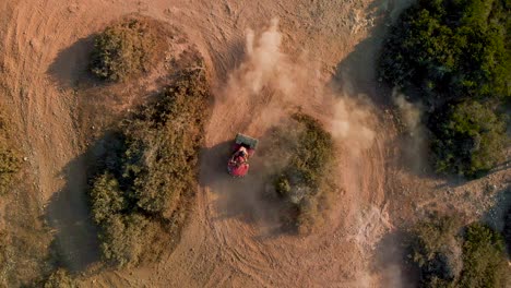 A-single-four-wheeler-dune-buggy-racing-in-circles-on-a-dirt-path-at-Cavo-Greko