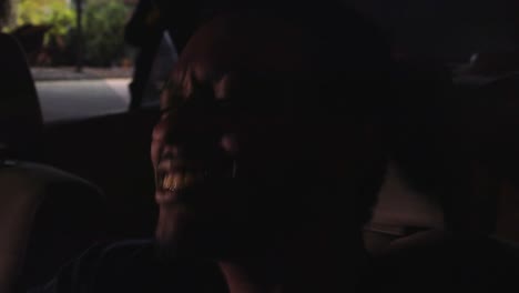 Black-man-jams-out-to-music-in-parked-car,-close-up