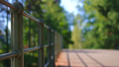 Short-depth-of-field-shot-of-a-handrail-and-a-bridge-with-changing-focus