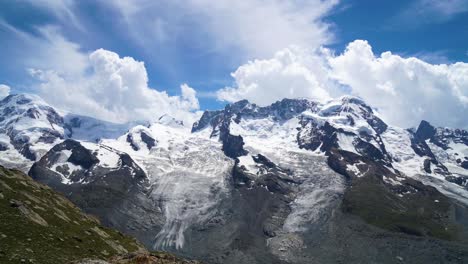 Timelapse-of-clouds-forming-and-being-pushed-by-the-wind-above-alpine-summits,-Zermatt---Switzerland