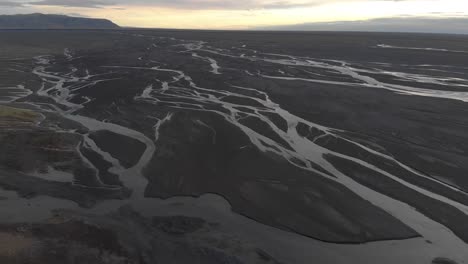 Aerial-Flyover-Glacial-Rivers-with-a-Low-Summer-Sun
