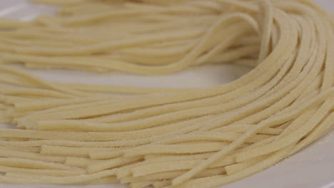Closeup-of-freshly-cut-pasta-noodles-placed-on-a-plate-before-cooking