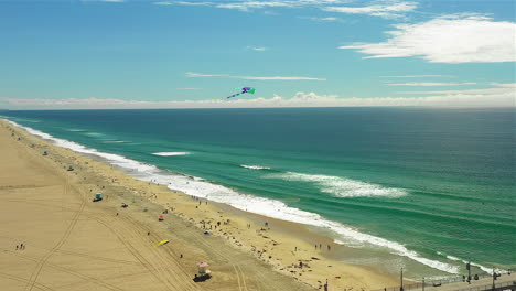Drone-footage-of-a-kite-flying-over-a-beach