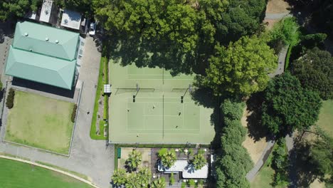 Static-aerial-shot-looking-directly-down-on-tennis-court-as-people-play