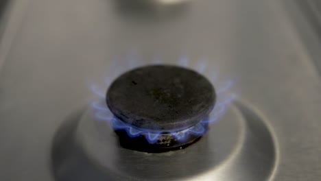 Real-gas-burner-on-used-cooker-hob-illustrating-to-turn-the-gas-down-to-avoid-waste