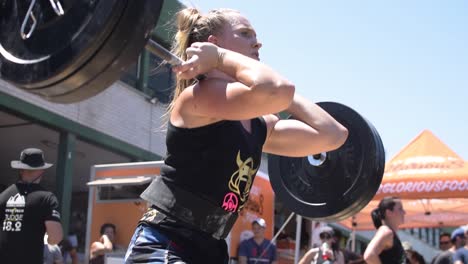 Tight-Shot-of-a-Focused-Female-Athlete-Performing-Front-Squats-at-a-Cross-Fit-Competition