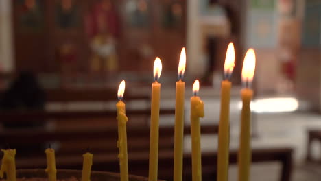 Six-Burning-Candles-With-Three-Faded-Away-Candle-Sticks-Inside-of-Madaba-St-George's-Greek-Orthodox-Church,-100-Frames-Per-Second