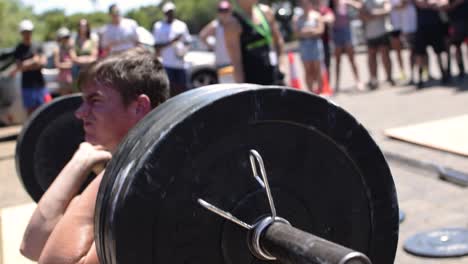 Young-Athlete-Working-Hard-to-Complete-a-Front-Squat-Lift-at-a-Crossfit-Competition