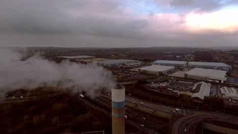 Aerial-footage-of-the-Stoke-on-Trent-incinerator-recycling-centre-in-the-midlands-Staffordshire,-garbage,-refuse,-waste-incineration-plant-with-smoking-smokestack-creating-more-industrial-pollution