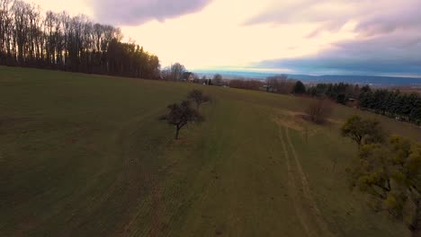 Drone-flight-over-hill-at-noon