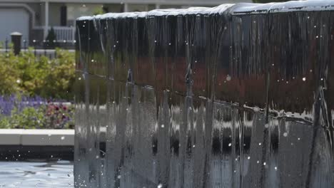 Water-falling-off-of-a-fountain-wall-into-water-in-120-fps-slow-motion