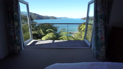 SLOWMO---Girl-lying-in-bed-in-luxury-retreat-with-amazing-view-of-Marlborough-Sounds,-New-Zealand