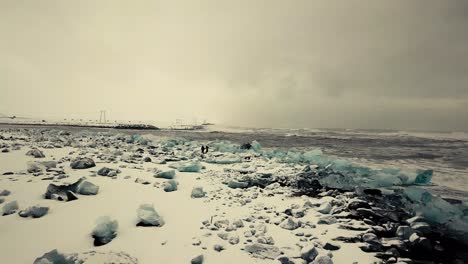 Cinematic-drone-moves-show-Black-sand-beach-in-Iceland-filmed-by-drone-in-snowy-conditions