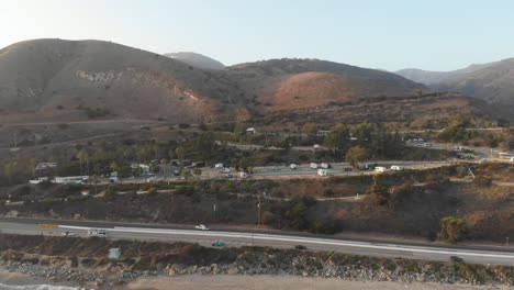 Aerial-in-Malibu,-California-of-campground-on-the-hillside-facing-the-beach