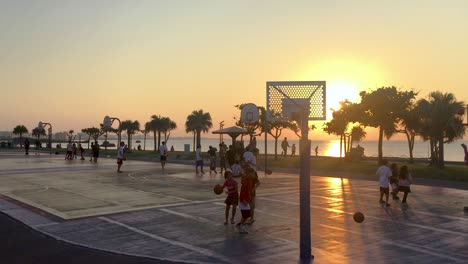 Pick-up-games-of-basketball-at-ocean-side-courts-during-sunset,-Location:-Chatan,-Okinawa,-Japan