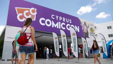 Wide-shot-of-the-entrance-as-people-go-into-Cyprus-Comic-Con-in-Nicosia,-Cyprus