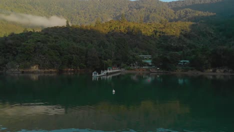 SLOWMO---Morning-aerial-flying-over-sea-towards-bay-in-Marlborough-Sounds,-New-Zealand,-cinematic-shot