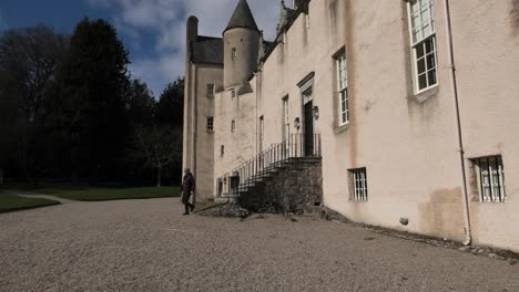 Drum-Castle-early-spring-morning-lady-comes-down-front-steps