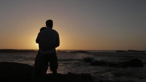 A-couple-hugging-and-kissing-in-the-beach-on-a-beautiful-sunset