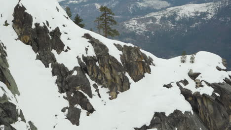 Snow-covered-granite-cliffs-from-Dewey-Point-in-Yosemite-National-Park-on-a-stormy-day
