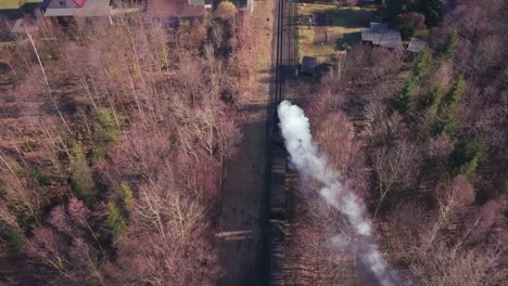 Following-the-steam-train-in-Germany,-Chasing,-aerial-view-of-a-railroad-in-Oybin,-near-Zittau