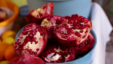 pomegranate-fruit-close-up-panning-right--whole-fruit-to-cut-up-pomegranate