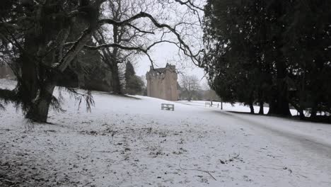 Crathes-Castle-in-snow-framed-by-tree-branches