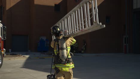 Firefighter-carries-a-ladder-towards-a-building