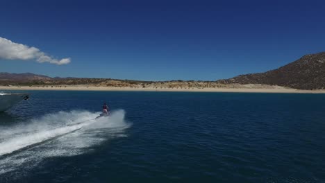 Aerial-shot-of-a-jet-ski-and-a-yacht-in-in-Cabo-Pulmo-National-Park,-Baja-California-Sur