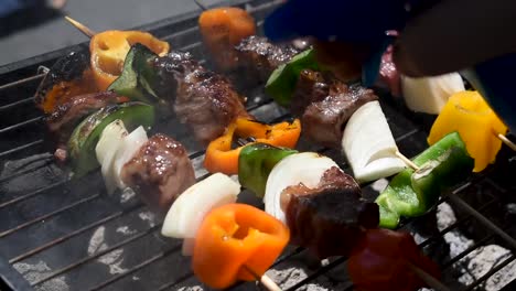 meat-and-vegetable-kabobs-over-hot-charcoal-briquettes-being-grilled-outdoors