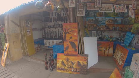African-roadside-souvenir-shop-with-handmade-ethnic-artifacts-in-Banjul,-Gambia
