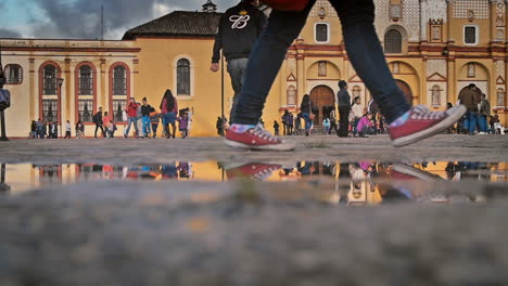 PEOPLE-PASSING-BY-AND-REFLECTION-MAIN-CATHEDRAL-IN-SAN-CRISTOBAL-DE-LAS-CASAS,-CHIAPAS-MEXICO-SHOT-PEOPLE-PASSING-BY