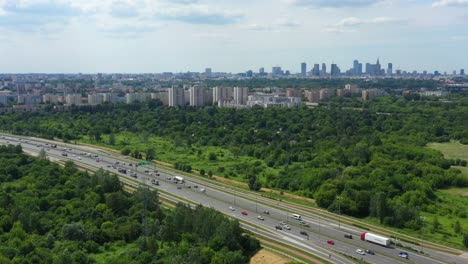 Top-view-over-the-highway,-expressway-and-motorway,-Aerial-view-interchange-with-car-driving-down-the-highway