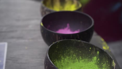 camera-panning-over-bowls-made-out-of-coconuts-with-color-powder-in-different-colors