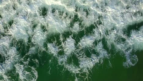 Aerial-drone-shot-looking-straight-down-at-the-surf-rolling-up-the-beach-at-Coolum