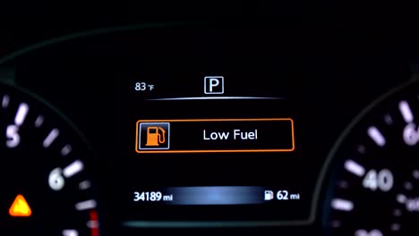 Low-fuel-warning-on-car-dashboard