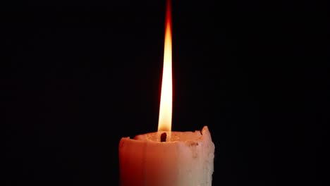 The-showcases-of-colorful-single-candlelight-on-black-background-with-the-effect-of-light-and-slow-motion
